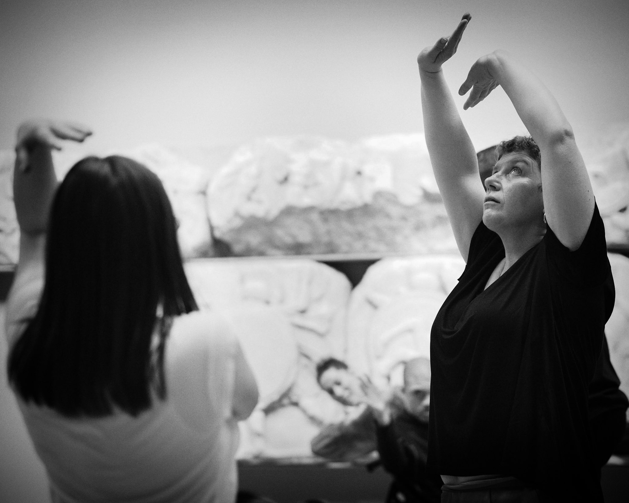 Black and white photo of Jackie at the British Museum dancing with her arms above her head